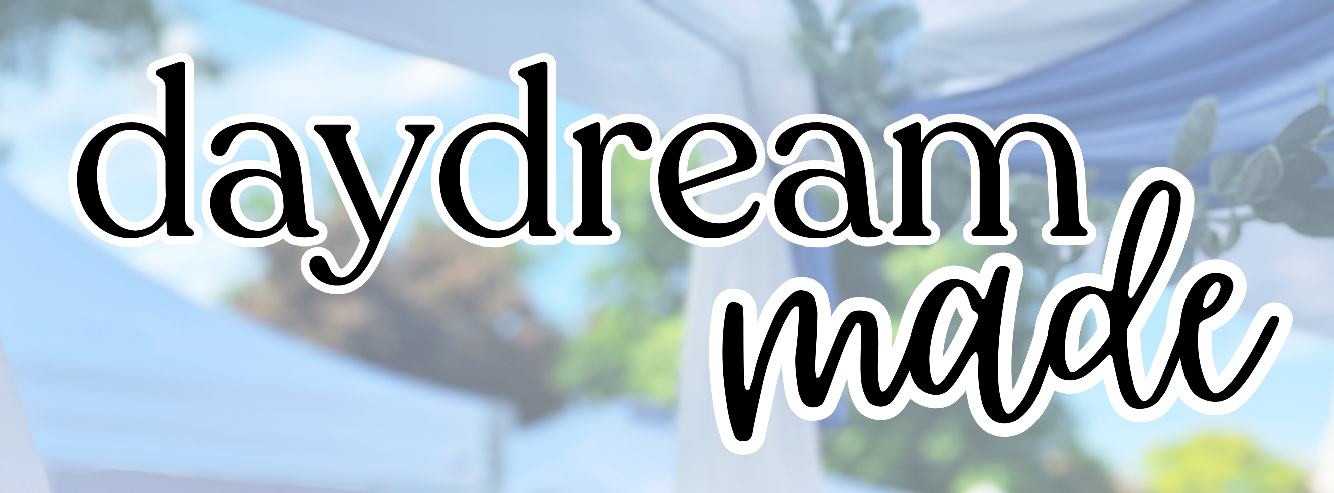 Text 'daydream made' with a blurred outdoor background